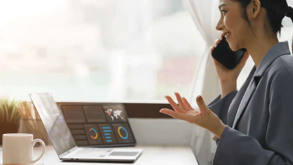 woman talking on the phone while looking over analytical insights