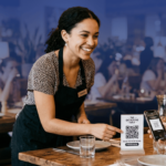 QR Code for Restaurants - image showing staff presenting the QR code to a restaurant client to place an order